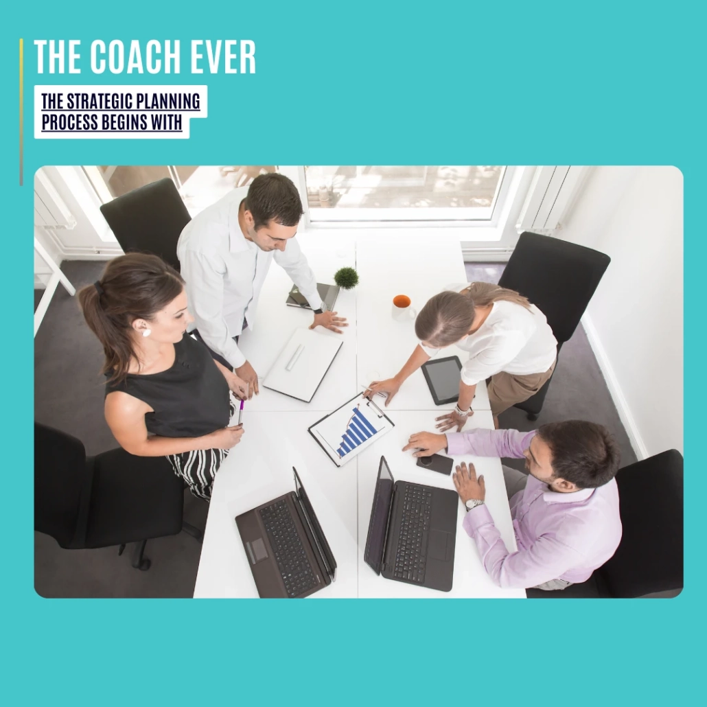 The Strategic Planning Process Begins With: a small team collaborating around a white table, reviewing charts and laptops during a focused planning session