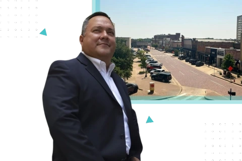 Business professional standing along a historic brick street in downtown Tyler, representing small business consulting in Tyler TX